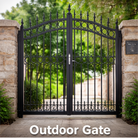 Black wrought iron gate with decorative top section in front of stone pillars and greenery.